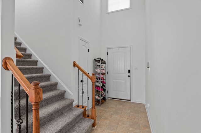 3430 Grove Landing Cir, Grovetown, GA 30813 - entrance foyer with baseboards, a high ceiling, stairway, and stone finish floors