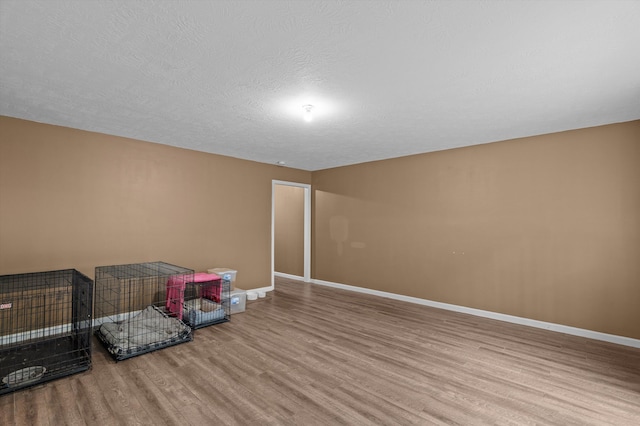 3430 Grove Landing Cir, Grovetown, GA 30813 - playroom with wood finished floors, baseboards, and a textured ceiling