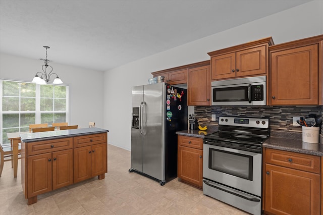 3430 Grove Landing Cir, Grovetown, GA 30813 - kitchen featuring appliances with stainless steel finishes, a chandelier, brown cabinetry, and dark countertops