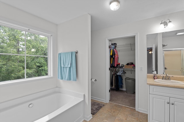 3430 Grove Landing Cir, Grovetown, GA 30813 - full bath with vanity, a garden tub, a spacious closet, a shower with door, and stone finish floors
