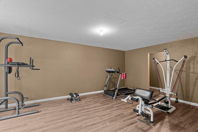 3430 Grove Landing Cir, Grovetown, GA 30813 - workout area featuring wood finished floors, baseboards, and a textured ceiling
