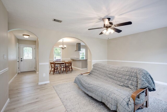 4122 Langley St, Martinez, GA 30907 - living area featuring arched walkways, light wood-type flooring, a ceiling fan, and a chandelier