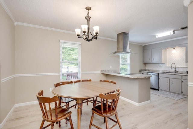 4122 Langley St, Martinez, GA 30907 - dining space featuring light wood-style flooring, crown molding, and a chandelier