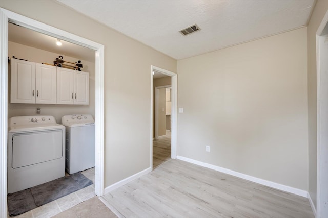 4122 Langley St, Martinez, GA 30907 - laundry area with cabinet space, washing machine and clothes dryer, and light wood-style flooring