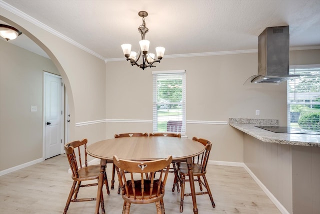 4122 Langley St, Martinez, GA 30907 - dining space featuring light wood finished floors, a chandelier, arched walkways, and ornamental molding