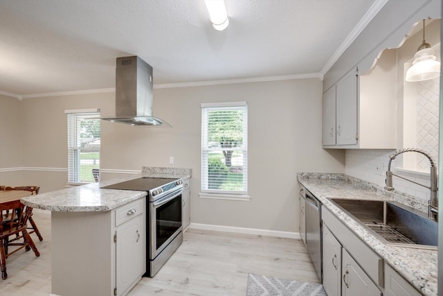 4122 Langley St, Martinez, GA 30907 - kitchen with island exhaust hood, appliances with stainless steel finishes, a peninsula, backsplash, and light wood-style floors