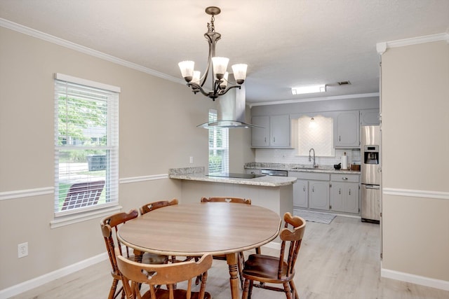 4122 Langley St, Martinez, GA 30907 - dining space with a chandelier, light wood-style flooring, and ornamental molding