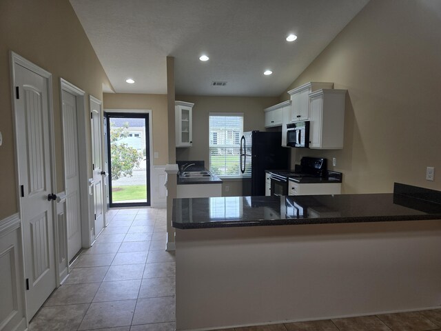412 York Ln, Augusta, GA 30909 - kitchen with black appliances, a peninsula, white cabinetry, light tile patterned floors, and recessed lighting