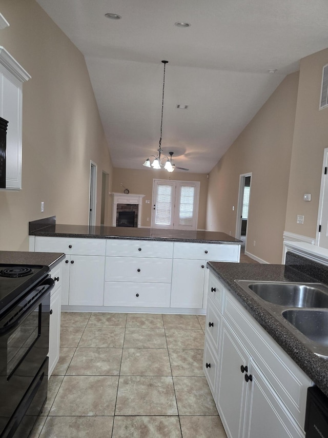 412 York Ln, Augusta, GA 30909 - kitchen featuring black range with electric stovetop, a chandelier, a fireplace, white cabinetry, and dark stone countertops