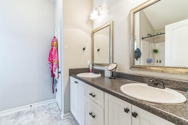 7105 Summerton Dr, Augusta, GA 30909 - bathroom featuring a shower, double vanity, a sink, and baseboards