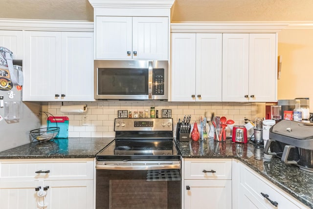7105 Summerton Dr, Augusta, GA 30909 - kitchen with dark stone countertops, tasteful backsplash, white cabinetry, and appliances with stainless steel finishes