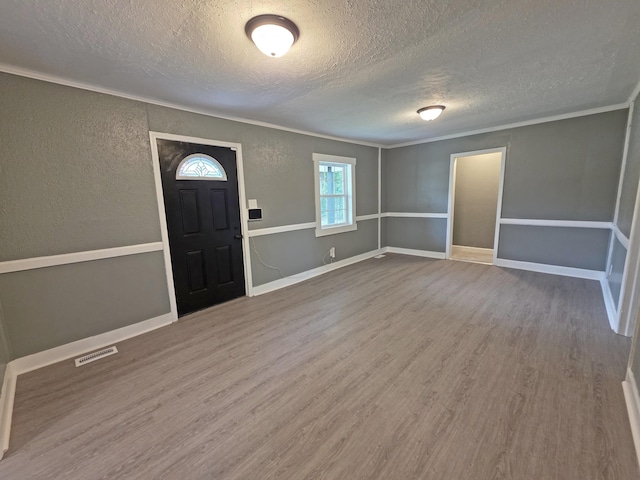 1005 Weston St, North Augusta, SC 29841 - foyer featuring a textured ceiling, a textured wall, wood finished floors, and ornamental molding