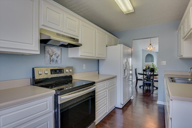 kitchen with under cabinet range hood, a sink, white cabinetry, dark wood-style floors, and stainless steel range with electric stovetop