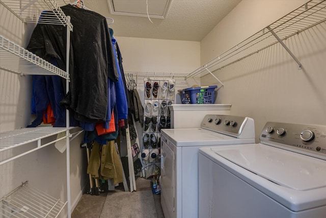 laundry area featuring laundry area, a textured ceiling, and washing machine and clothes dryer