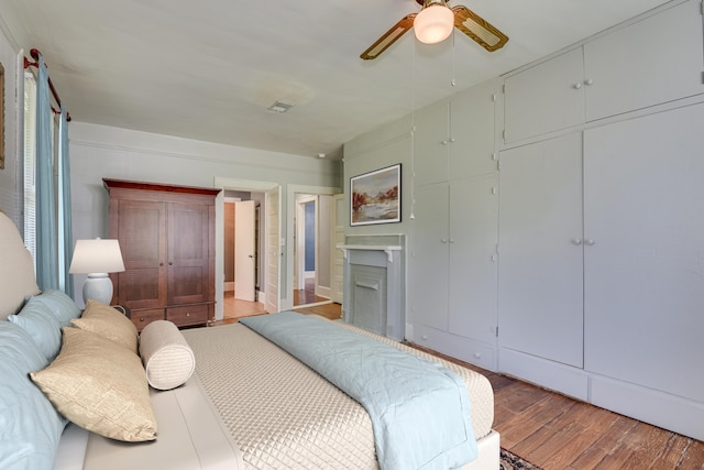 844 Heard Ave, Augusta, GA 30904 - bedroom with light wood-style flooring, a fireplace, and ceiling fan
