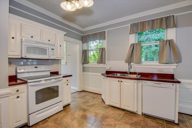 844 Heard Ave, Augusta, GA 30904 - kitchen with white appliances, backsplash, dark countertops, crown molding, and a chandelier