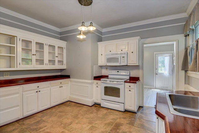 844 Heard Ave, Augusta, GA 30904 - kitchen with white appliances, dark countertops, glass insert cabinets, ornamental molding, and decorative light fixtures
