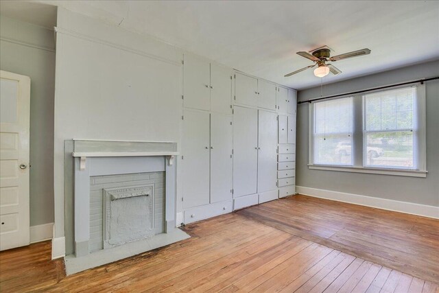 844 Heard Ave, Augusta, GA 30904 - unfurnished living room with ceiling fan, light wood-style flooring, and a brick fireplace