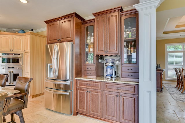 139 Laurens Dr, Mccormick, SC 29835 - kitchen featuring stainless steel appliances, stone tile floors, ornamental molding, light stone counters, and glass insert cabinets