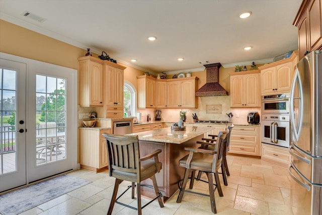 139 Laurens Dr, Mccormick, SC 29835 - kitchen with custom range hood, stainless steel appliances, crown molding, stone tile flooring, and a kitchen island