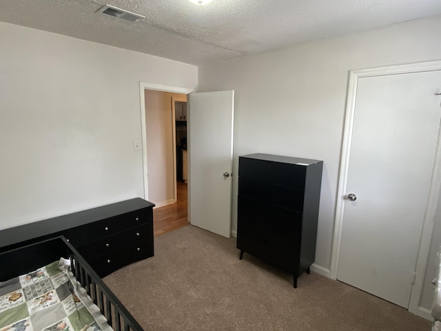 3406 Pine Hill Rd, Hephzibah, GA 30815 - unfurnished bedroom featuring light colored carpet, a textured ceiling, and visible vents