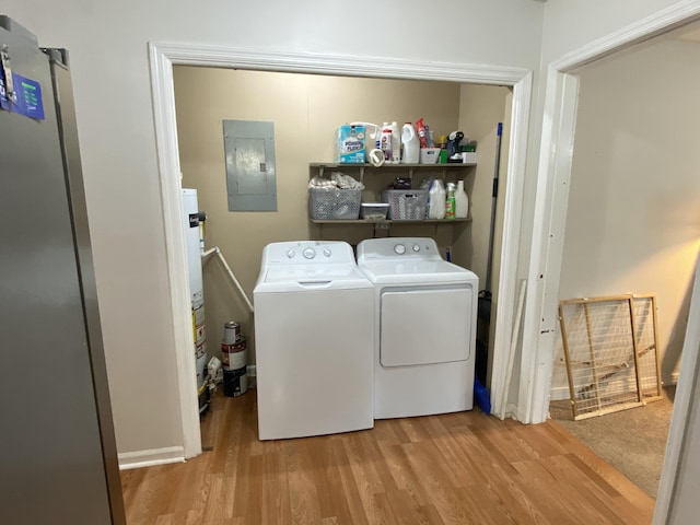 3406 Pine Hill Rd, Hephzibah, GA 30815 - laundry area with washer and dryer, laundry area, water heater, wood finished floors, and electric panel