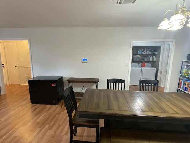 3406 Pine Hill Rd, Hephzibah, GA 30815 - dining space featuring independent washer and dryer, visible vents, an inviting chandelier, and light wood finished floors