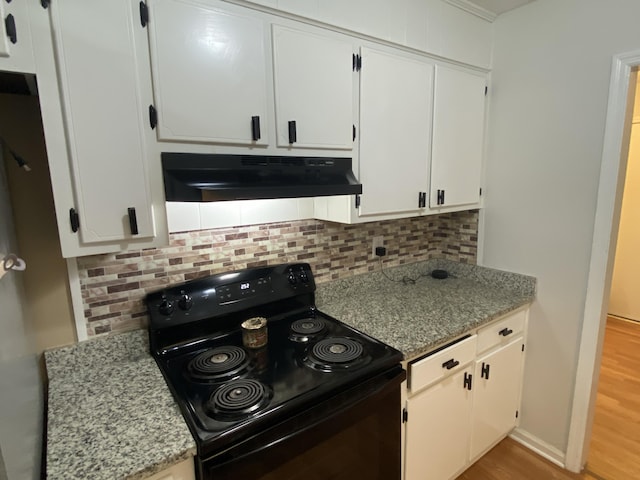 3406 Pine Hill Rd, Hephzibah, GA 30815 - kitchen with tasteful backsplash, black electric range oven, white cabinets, light wood-style floors, and under cabinet range hood