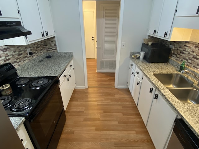 3406 Pine Hill Rd, Hephzibah, GA 30815 - kitchen with light wood-style floors, ventilation hood, white cabinetry, a sink, and black appliances