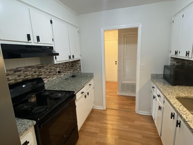 3406 Pine Hill Rd, Hephzibah, GA 30815 - kitchen featuring decorative backsplash, white cabinetry, under cabinet range hood, light wood finished floors, and black appliances