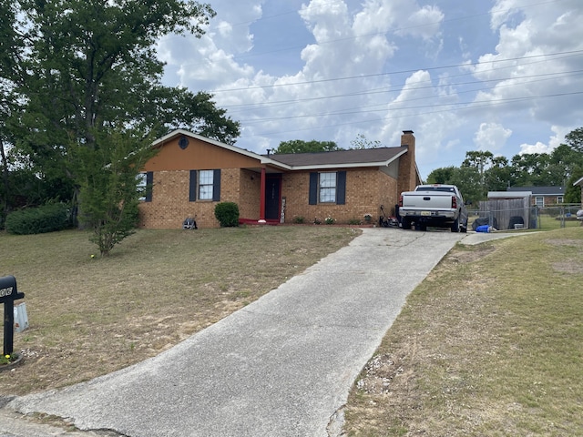 3406 Pine Hill Rd, Hephzibah, GA 30815 - ranch-style house featuring fence, brick siding, a front yard, a chimney, and driveway