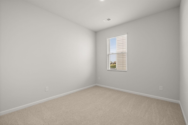 unfurnished room with visible vents, baseboards, and carpet