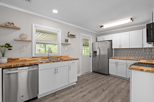 3589 Jonathan Cir, Augusta, GA 30906 - kitchen featuring wood counters, stainless steel appliances, open shelves, white cabinets, and ornamental molding
