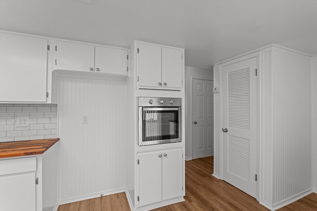 4004 Columbia Rd, Martinez, GA 30907 - kitchen with stainless steel oven, wood finished floors, and white cabinets