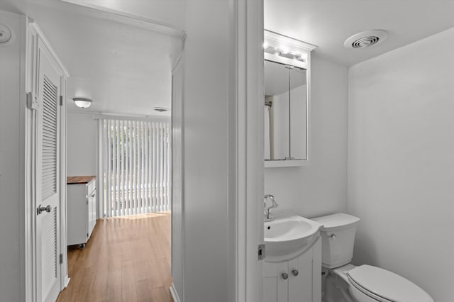 4004 Columbia Rd, Martinez, GA 30907 - bathroom featuring toilet, vanity, wood finished floors, and a closet