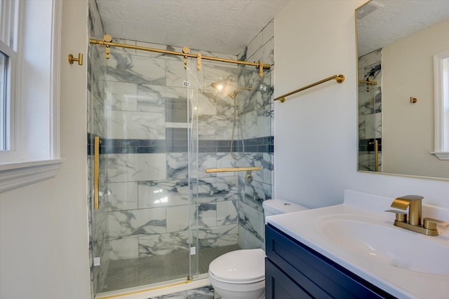 bathroom with a textured ceiling, a marble finish shower, and toilet