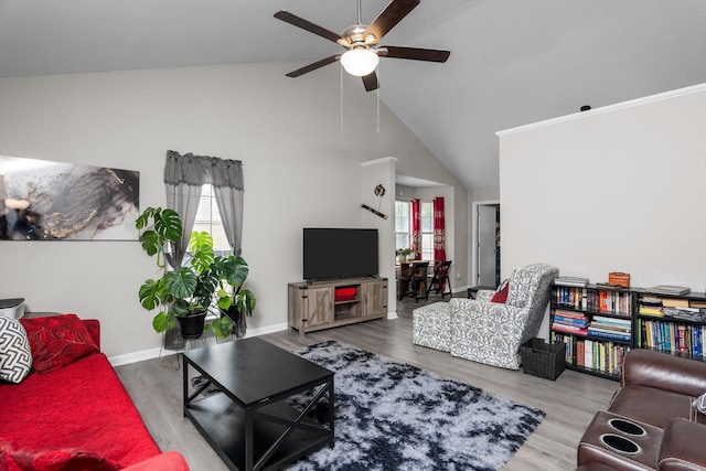 106 Allie Rd, Wrens, GA 30477 - living area featuring ceiling fan, wood finished floors, high vaulted ceiling, and baseboards