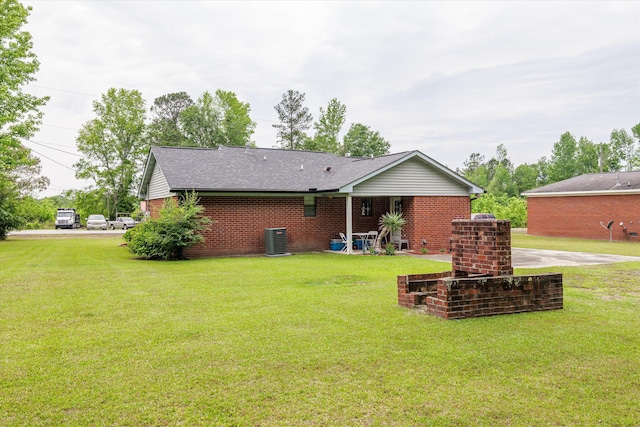 106 Allie Rd, Wrens, GA 30477 - back of house featuring a lawn, cooling unit, brick siding, and a shingled roof