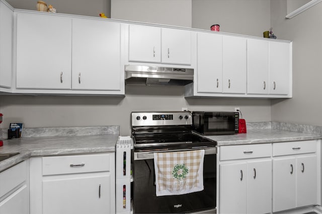 106 Allie Rd, Wrens, GA 30477 - kitchen with stainless steel electric range oven, under cabinet range hood, black microwave, and light countertops