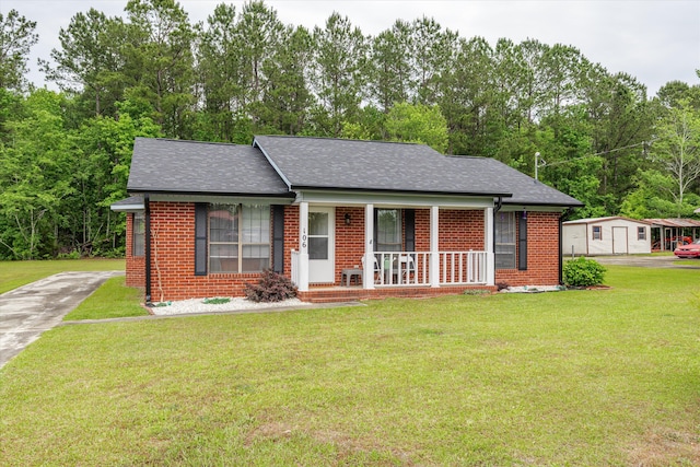 106 Allie Rd, Wrens, GA 30477 - view of front of property featuring a porch, brick siding, driveway, a front yard, and a shingled roof