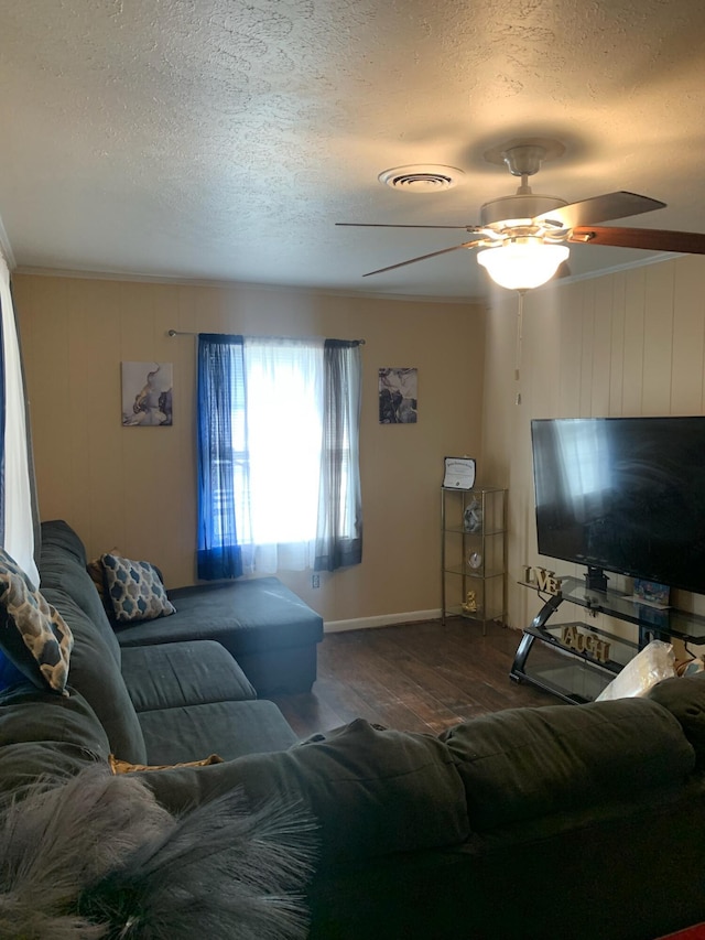 living room with hardwood / wood-style floors, ceiling fan, and a textured ceiling