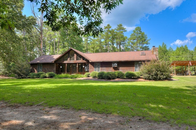 log home featuring a pergola and a front lawn