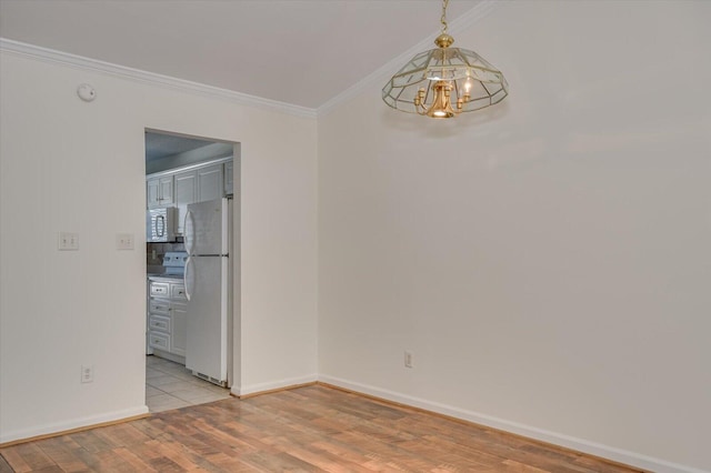 unfurnished room with light wood-style flooring, a chandelier, baseboards, and ornamental molding