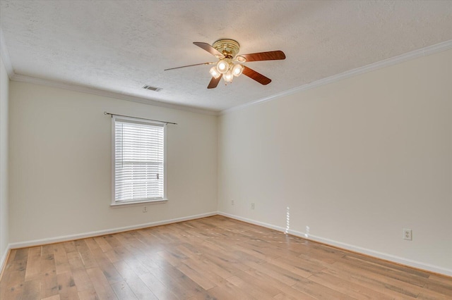 unfurnished room with light wood finished floors, visible vents, a textured ceiling, and ornamental molding