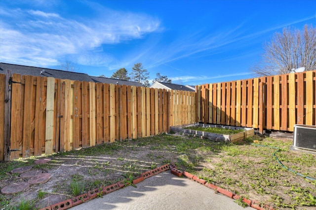 view of yard with a garden and a fenced backyard