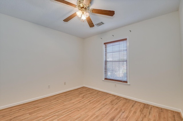 unfurnished room featuring visible vents, ceiling fan, light wood-style flooring, and baseboards