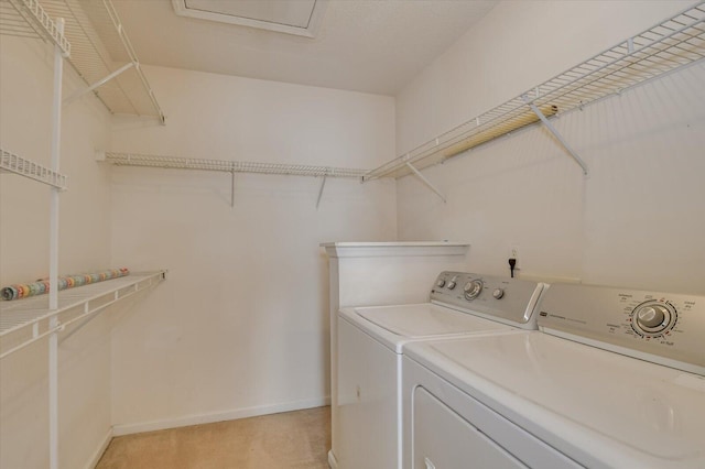 washroom featuring laundry area, separate washer and dryer, light colored carpet, and baseboards