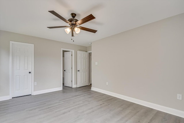 unfurnished bedroom with ceiling fan and light hardwood / wood-style floors