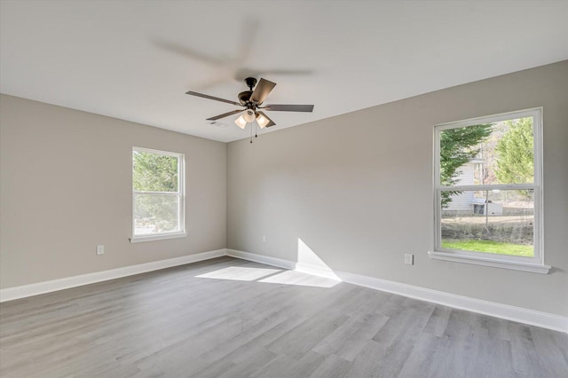 empty room featuring ceiling fan and light wood-type flooring