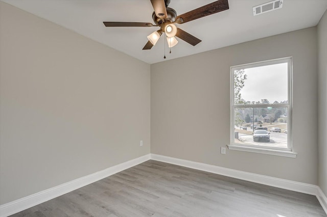 spare room featuring ceiling fan and light hardwood / wood-style flooring